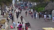 El momento en que la gente corre para protegerse tras el estallido de los disparos en Hollywood Beach