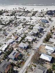 This aerial photo shows damaged homes and debris in the aftermath of Hurricane Ian, Thursday, Sept. 29, 2022, in Fort Myers, Fla. (AP Photo/Wilfredo Lee)